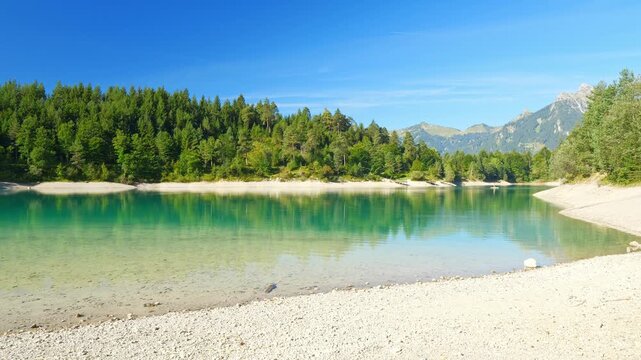 Summer Mountain Lake with Turquoise Waters and Blue Skies: Perfect Holiday Spot with Beach and Breathtaking Mountain Scenery - Urisee - Reutte - Tyrol - Austria