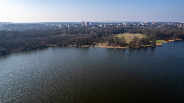 drone aerial view over rusalka lake in poznan in winter time with sun and no snow