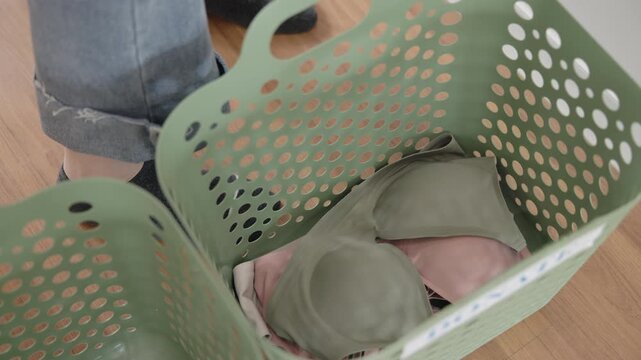 Young adult woman asia people arrange stack undies sale manage used old bra bank neat basket box clean house closet eco care. Happy asian smile go green wife home chores net zero waste fabric issue.