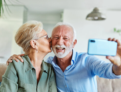 senior woman man couple elderly love elderly selfie camera mobile phone smartphone photo picture portrait male old together active vitality cell phone hug - Powered by Adobe