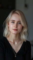 Fototapeta premium Young Woman With Blonde Hair in a Black Top Posing Indoors