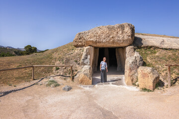 Caucasian mature woman visiting the dolmen of Antequera, Malaga, Spain.