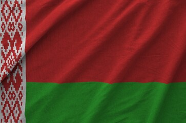 Belarus flag depicted on folded wavy fabric of old cloth close up