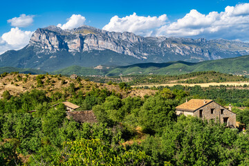 View of the Spanish Pyrenees and the Ordesa valley with small mountain houses at its feet.