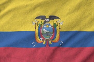 Ecuador flag depicted on folded wavy fabric of old cloth close up