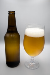 A bottle, a mug with light beer.
