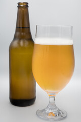 A bottle, a mug with light beer.
