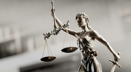 Legal Concept: Themis is the goddess of justice as a symbol of law and order on the background of books