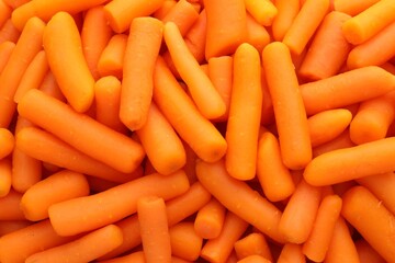 Many baby carrots as background, top view