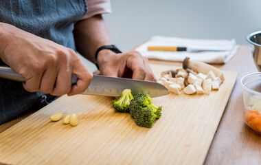 Chef at the kitchen preparing healthy quinoa bowl with avocado