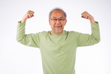 Naklejka premium Portrait Asian grey haired smiling senior man flexing muscles and smiling studio shot isolated on white background, elderly showing off very strong and healthy
