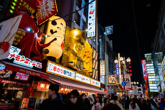 Osaka, Japan - Jan 08, 2024: Tourist walking shopping street food at Dotonbori or dotombori, Dotonbori the famous destination for traveller in Shinsaibashi, Osaka City, Osaka, Japan.