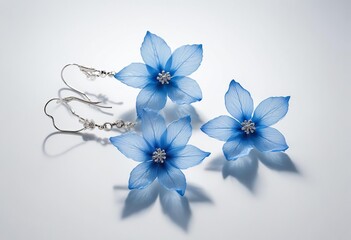 A close-up photograph of a delicate blue flower earring