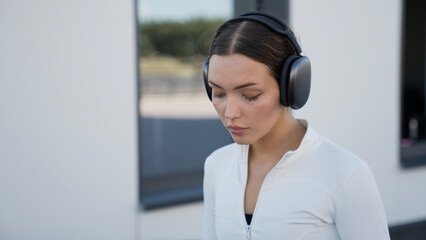 portrait of beautiful young woman wearing headphones listening to music enjoying favourite songs