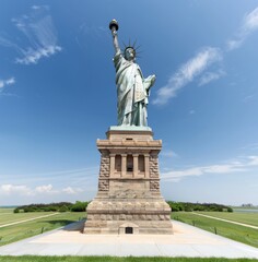 The Statue of Liberty stands tall against the blue sky, symbolizing freedom and adventure for all who come to New York City. The biomechanical girl is in the style of Sylvania documentary footage.