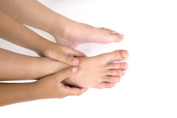 Leg pain, woman suffering from leg pain uses manual massage to relax the sole muscles.