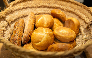 Bread, buns and bakery products are sold in a bakery. Homemade fresh bread in a wicker basket. Delightful assortment of freshly baked pastries. Food banner