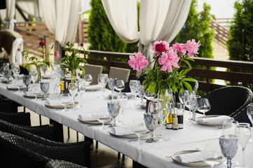 table in a restaurant decorated with flowers and candles.