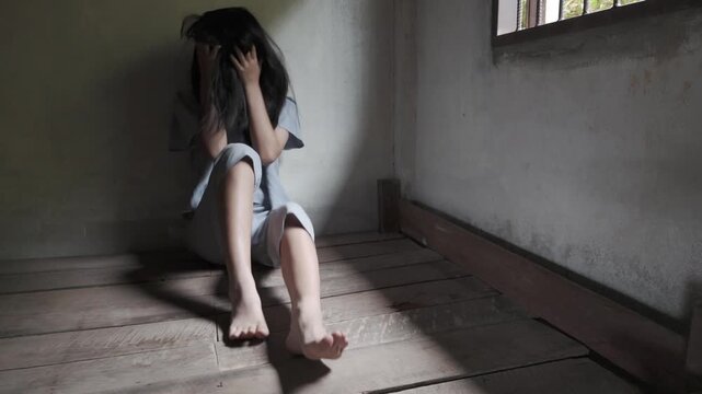 Young depressed woman in trouble pulling her hair with hands and crying sitting on Wooden bed. Slow motion shot