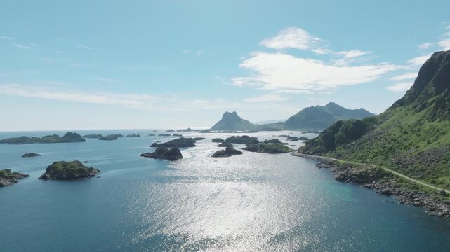 Mountain range and sea on a sunny day with blue skies in Lofoten during the summ