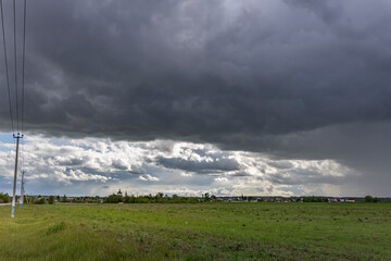 A stormy sky with a tall power line in the background