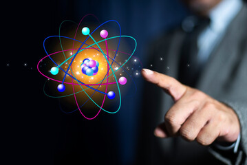 Bussinessman finger pointing creative atom on blue background. Nuclear fusion concept, endless...