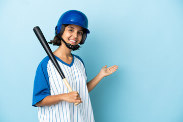 Baseball mixed race player woman with helmet and bat isolated on blue background extending hands to the side for inviting to come