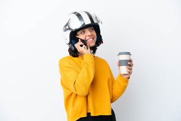 Woman with a motorcycle helmet holding coffee to take away and a mobile
