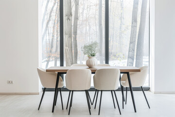 Luxury living room interiors with a dining table next to a window filling the room with natural lighting. Chic residential Real Estate interiors.