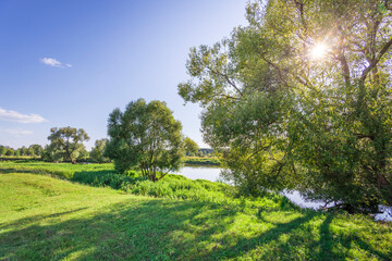 A beautiful sunny day with a river in the background