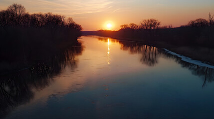 Obraz premium A serene sunset casting warm hues over a tranquil river, captured in a raw AR style.