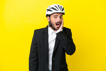 Business caucasian man with a bike helmet isolated on yellow background with surprise and shocked facial expression