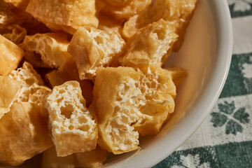 A bowl of fried, sliced tofu puffs, a classic Asian ingredient