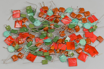 Different ceramic and film fixed capacitors on a gray surface