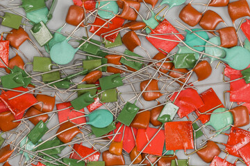Heap of different ceramic and film fixed capacitors, top view