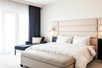Luxurious hotel room interiors in warm tones with chic decor and natural lighting.