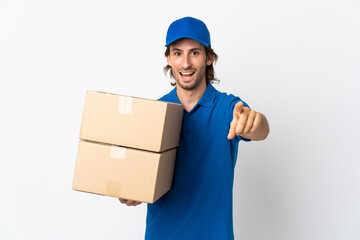 Delivery man isolated on white background surprised and pointing front