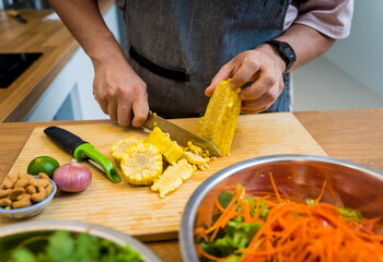 Chef at the kitchen preparing spicy glass noodle salad