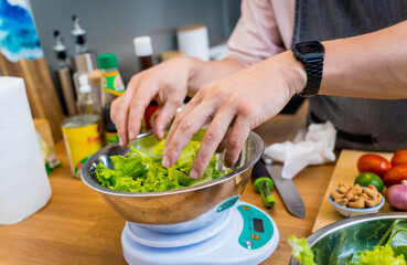 Chef at the kitchen preparing spicy glass noodle salad