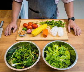 Chef at the kitchen preparing spicy glass noodle salad