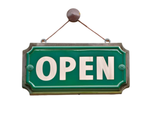 A classic green wooden open sign hanging from a chain, inviting customers into a business or store.