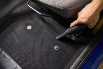 Car interior cleaning includes thorough cleaning under pedals for a tidy interior