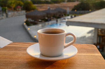 Black coffee on the background of the pool