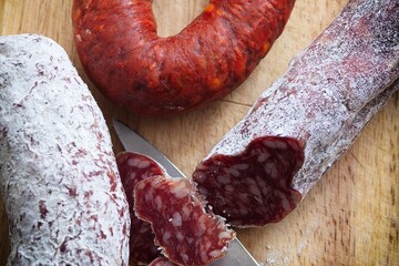 Close-Up 4K image of Slicing Very Thin Salami Sausage for Charcuterie
