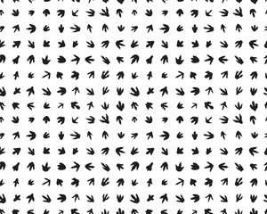 Seamless pattern with footprints of dinosaurs