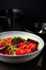 Gourmet Delight: Close-Up 4K Image of Healthy Vegan Beetroot Risotto with Garlic Rosemary Oil and Rocket Leaf Garnish
