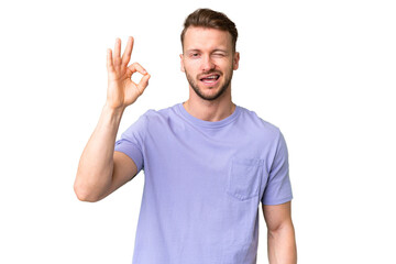 Naklejka premium Young handsome caucasian man over isolated chroma key background showing ok sign with fingers