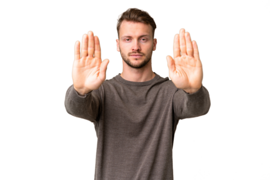 Young handsome caucasian man over isolated chroma key background making stop gesture and disappointed