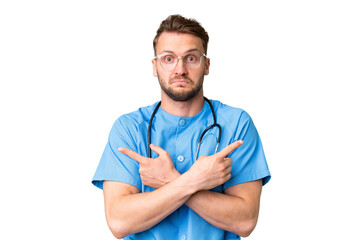 Young nurse man over isolated chroma key background pointing to the laterals having doubts
