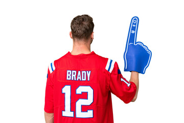 Young caucasian sports fan man over isolated chroma key background in back position